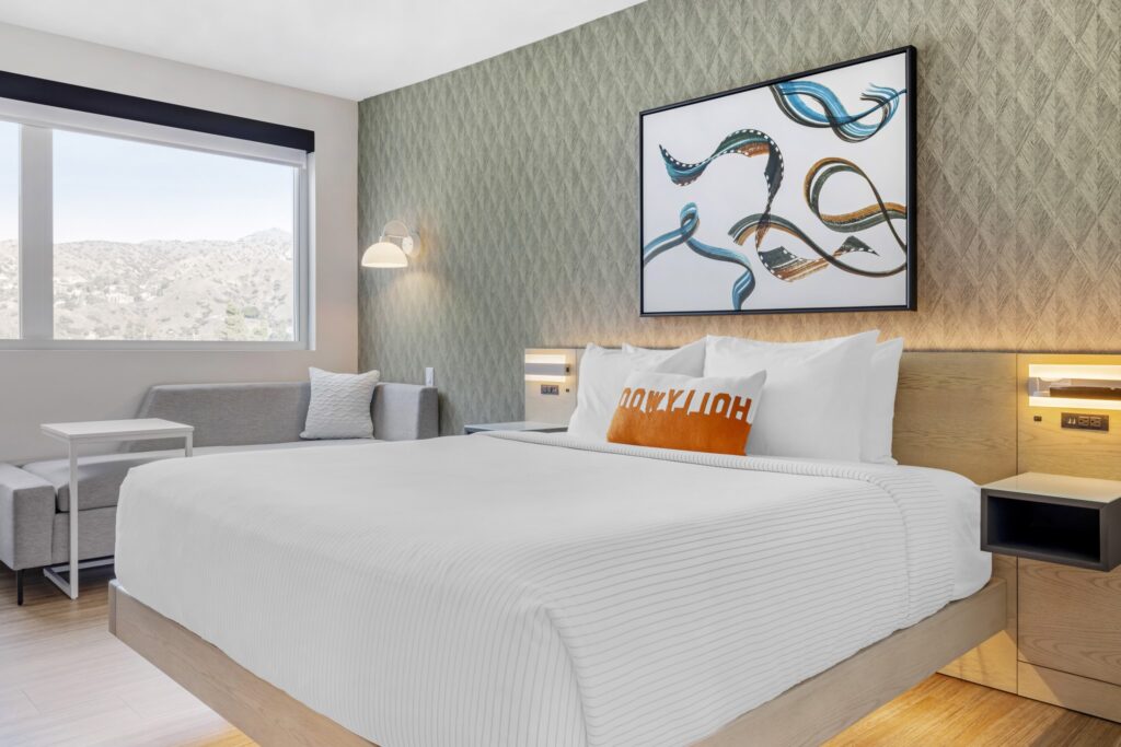 Room at Cambria Burbank with king bed large window and artwork