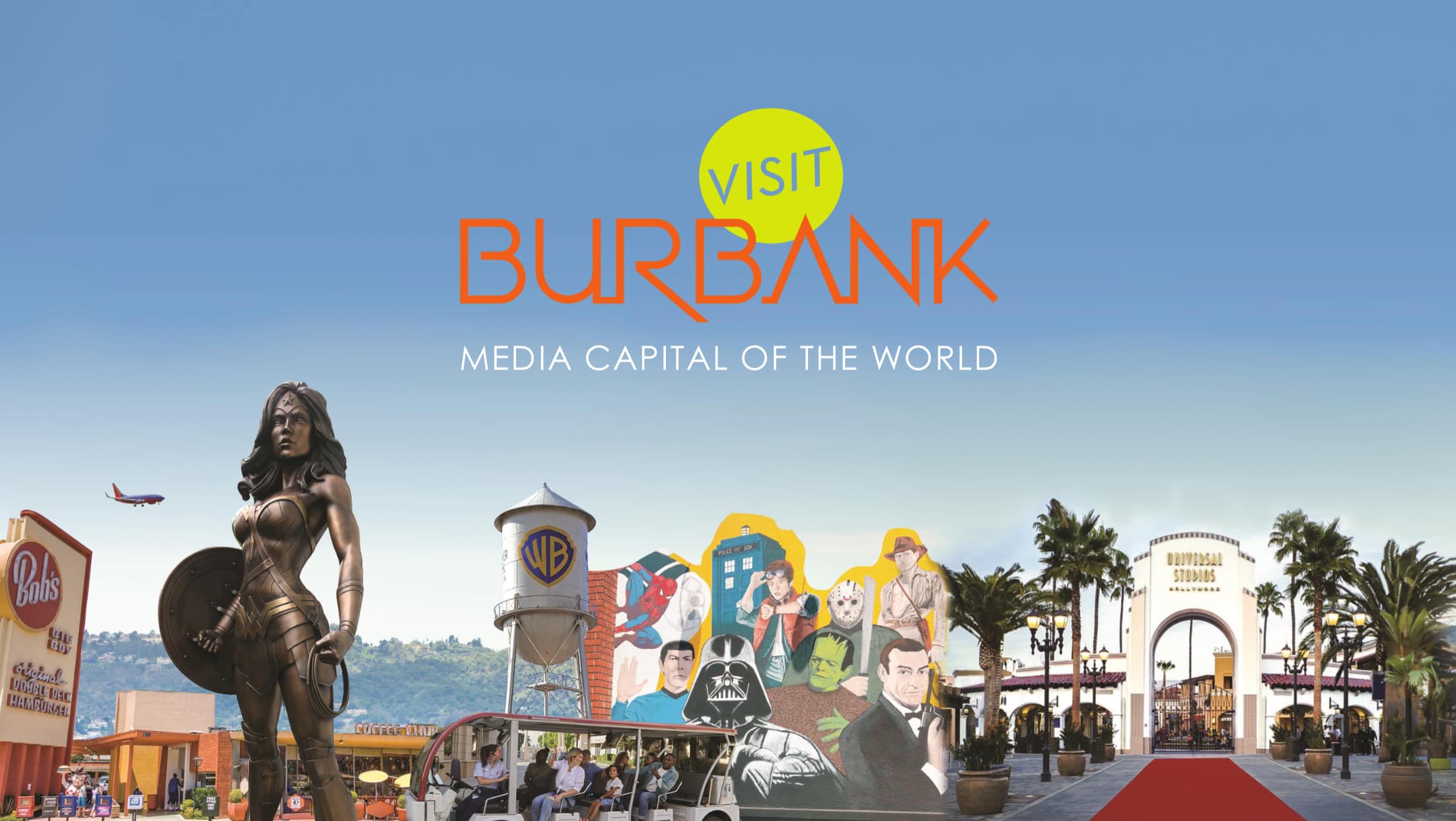 Sky‑blue promotional banner reading ‘Visit Burbank: Media Capital of the World’ above a montage featuring a bronze Wonder Woman statue, a Warner Bros. water tower, cutouts of film and TV icons (Spider‑Man, the TARDIS, Darth Vader, Jason Voorhees, Indiana Jones, Frankenstein, James Bond, Marty McFly), a Bob’s Big Boy sign, visitors on a tram, and the red‑carpeted entrance to Universal Studios Hollywood framed by palm trees and hills.