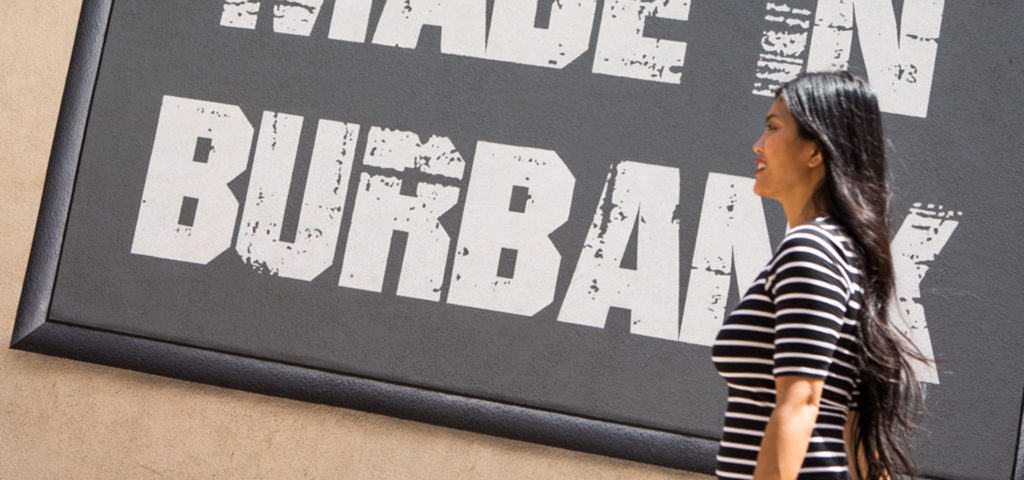 Woman Walking in front of a 'made in burbank' sign